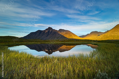 A beautiful small mountain lake in Sarek National Park, Sweden during august. Summer landscape of northern wilderness in Scandinavia.