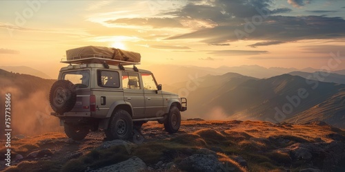 SUV with rooftop cargo on a mountain road at sunset. photo