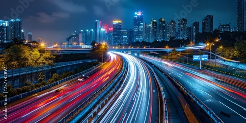 Long exposure of city highway traffic at night with neon light trails.