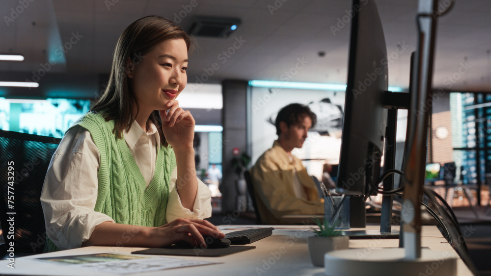 Asian Woman Using Desktop Computer And Designing In 3D Modelling Software Unique World And Characters For Survival Video Game In Diverse Office. Female Game Designer Creating Immersive Gameplay Asian Woman Using Desktop Computer And Designing In 3D Modelling Software Unique World And Characters For Survival Video Game In Diverse Office. Female Game Designer Creating Immersive Gameplay