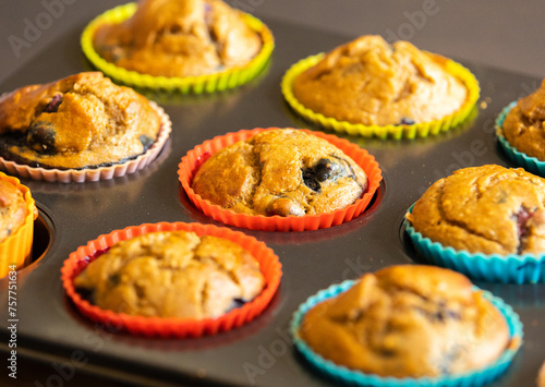  A close-up shot of homemade vegan banana blueberry muffins arranged in a baking tray