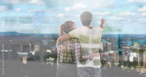 Image of windows over couple embracing looking at cityscape