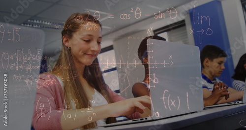 Image of mathematical equations over schoolchildren using laptop