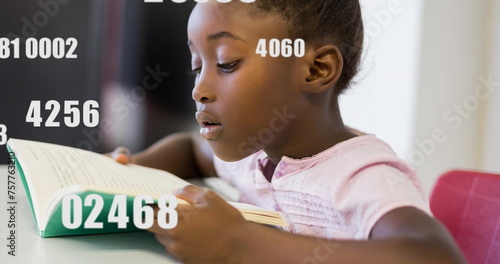 African American girl focused on reading a book at school
