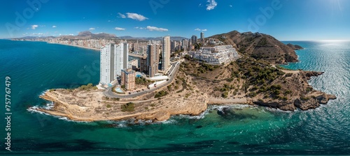 Extremely wide aerial drone photo of the norther part of Benidorm in Spain showing the Cala Almadraba Beach and the main Llevant beach on a sunny day in the summer time. photo