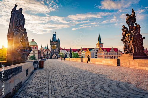 Stunning spring sunrise on Charles bridge over Vltava river (Karluv Most) with statues and Prague castle. Attractive morning cityscape in Prague, Czech Republic, Europe. Traveling concept background.. photo