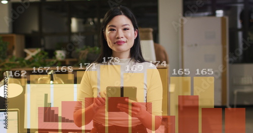 Image of financial data processing over asian businesswoman working in office