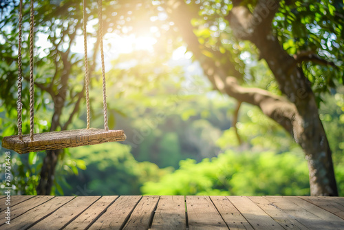wooden table top and a swing with a blurred image of nature on a bokeh background are used to showcase products or anything else. The concept of a summer vacation in nature, a family picnic photo