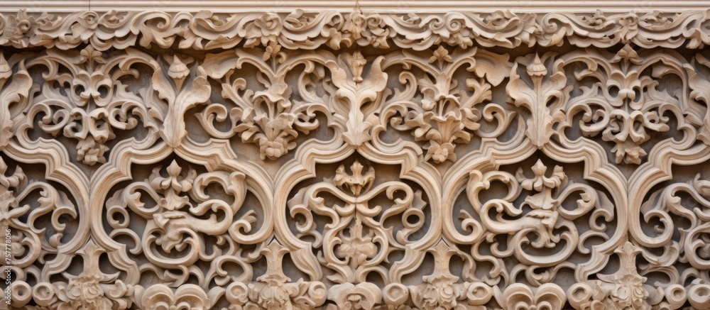 A detailed stone carving with a symmetrical motif is displayed on a beige wall, showcasing ancient history through intricate patterns and visual arts