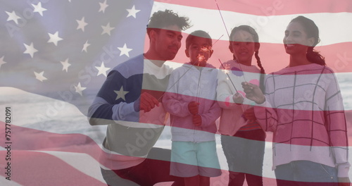 Image of flag of united states of america over biracial couple with children by seaside