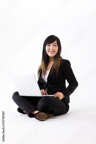 Portrait of a stylish Asian Businesswoman using a laptop.