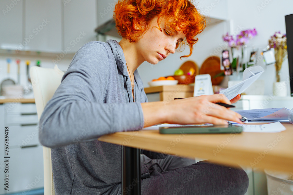 portrait attractive teenage girl filling out paper form