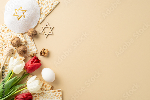 Graceful Passover arrangement, top view shot. Includes ribboned matzah, rwalnuts, egg, star of David, yarmulke, white and red tulips on a gentle beige background, space for copy