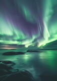 Green and Purple Aurora Borealis Dancing Over a Body of Water