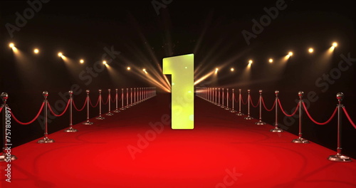 Image of countdown to midnight over red carpet and spots of light on black background