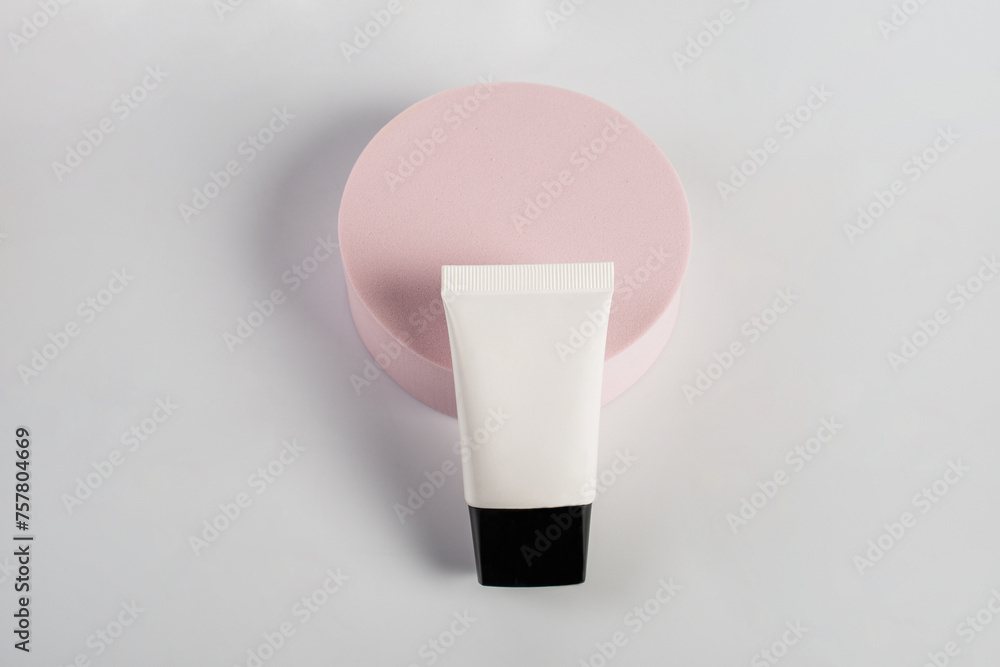Plastic white tube for cream or lotion. Skin care or sunscreen cosmetic with stylish props on white background. Plastic white tube for cream or lotion. Skin care or sunscreen cosmetic with stylish props on white background.