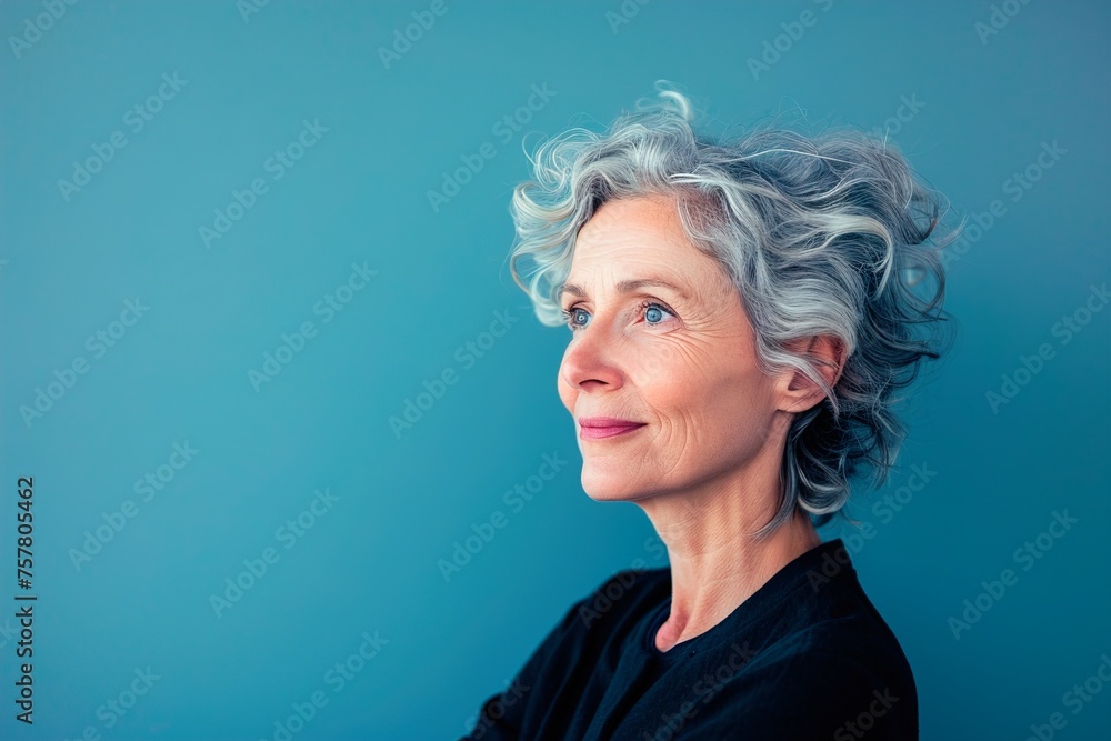 A woman with gray hair and a blue background
