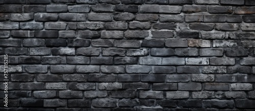 A close up of a grey brick wall showcasing the rectangular pattern of the brickwork and mortar. The monochrome photography highlights the composite material of the building