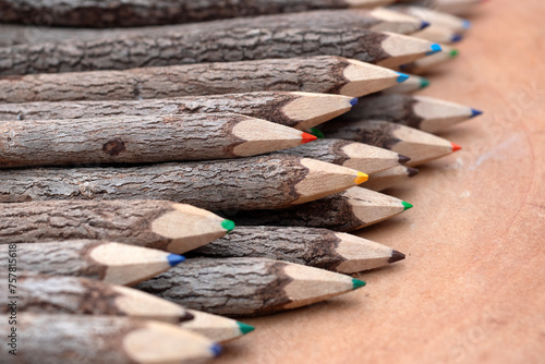 Color Pencils made of branches on on a wood desk.