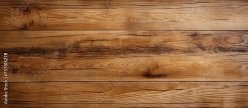 A closeup of a brown hardwood plank flooring with a blurred background, showcasing the beauty of wood stain and varnish on each rectangular lumber building material