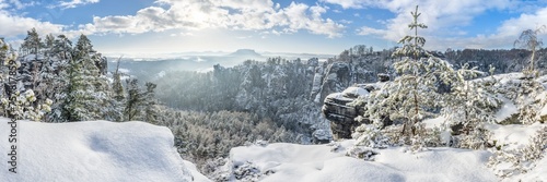 Snowy winter landscape in the Elbe Sandstone Mountains (Elbsandsteingebirge), Saxon Switzerland (Sächsissche Schweiz), Saxony, Germany photo