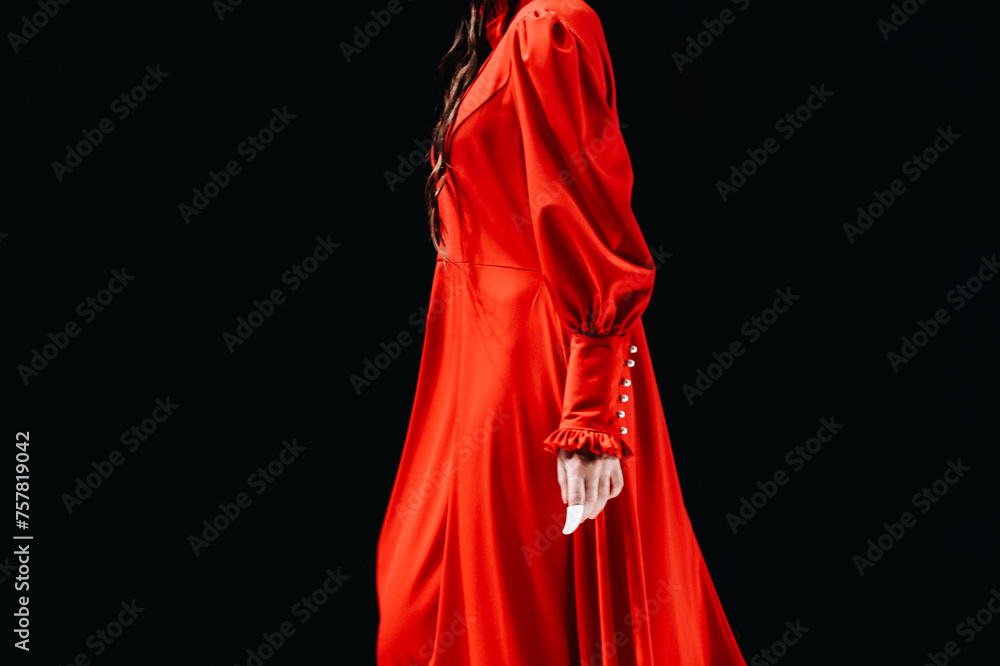 Fototapeta premium Details of a bright red long dress. Women's elegant fashion