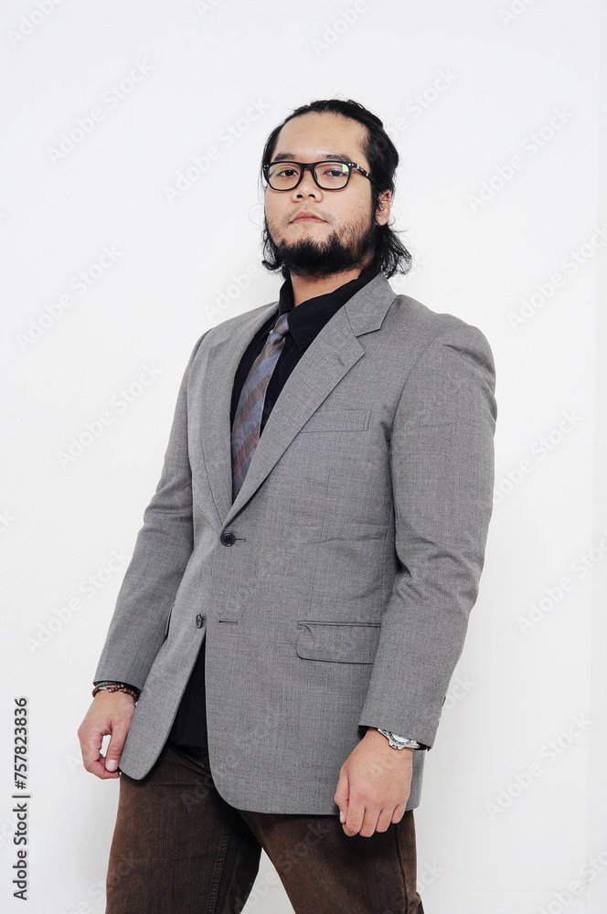 Portrait of an Asian man wearing glasses wearing a black shirt, complete with jacket and tie, on a white background Portrait of an Asian man wearing glasses wearing a black shirt, complete with jacket and tie, on a white background