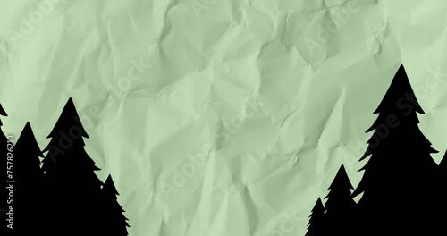 Image of pine tree silhouettes over moving scrunched paper background