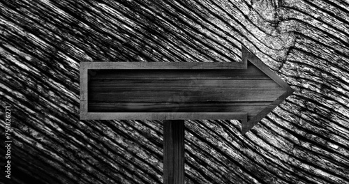 Image of wooden arrow sign over changing wood grain pattern, black and white
