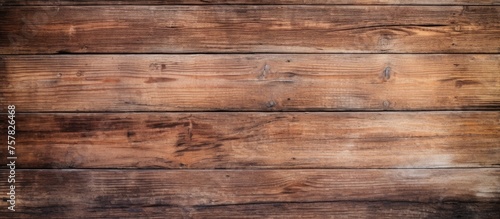 A detailed closeup of a brown hardwood plank wall with a blurred background, showcasing the intricate pattern of the wood flooring