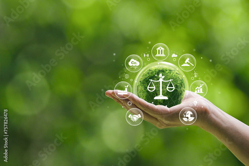 Concepts of international environmental law climate justice Ideas of environmental protection laws for sustainable business organizations and industries. Hand holding a green globe