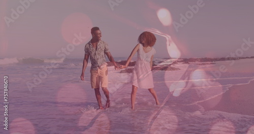 Image of light spots over african american couple walking and dancing