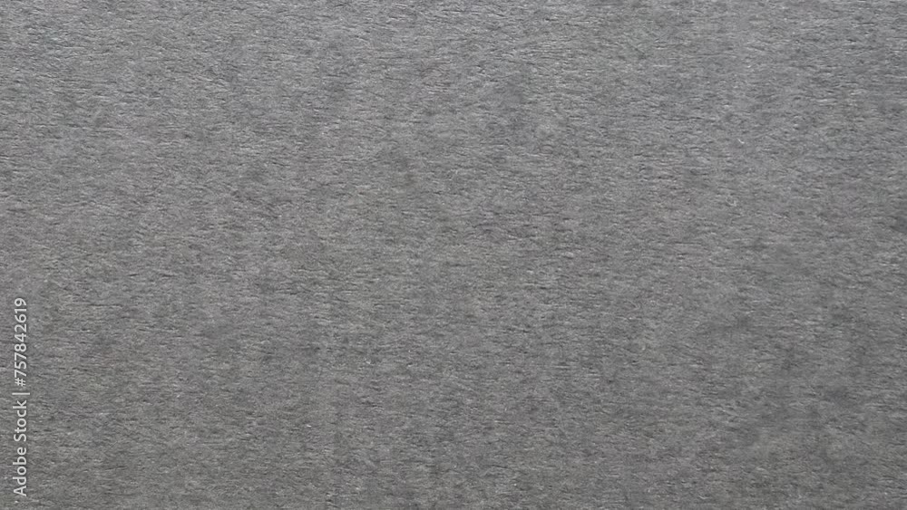 Recycled dark gray colored tinted paper motion video background. Dynamic changing rough dark paper sheet texture. Grunge backdrop animation. Recycled dark gray colored tinted paper motion video background. Dynamic changing rough dark paper sheet texture. Grunge backdrop animation.
