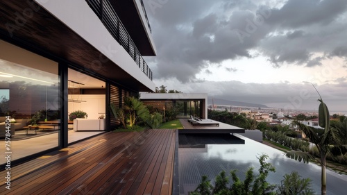 A large house with a pool and a balcony overlooking the city. The house is surrounded by trees and has a wooden deck. The sky is cloudy, giving the scene a moody atmosphere © Bambalino Studio
