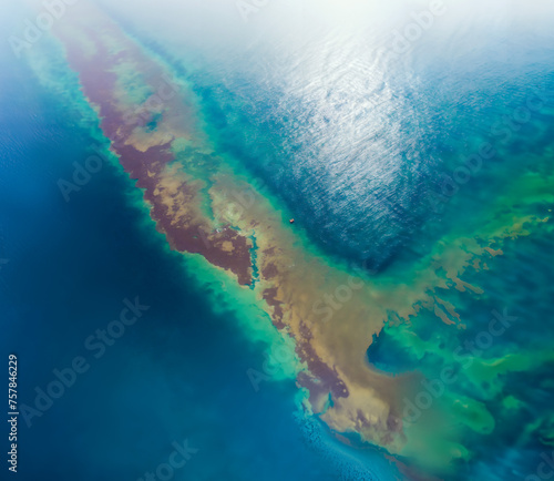 Oil spill pollution at sea, aerial view.