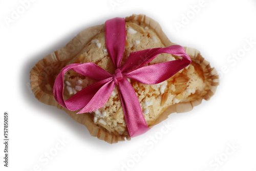 Sweet Easter cake named Colomba Pasquale (Easter dove) with pink tied bow isolated on white background. Italian traditional pastry 