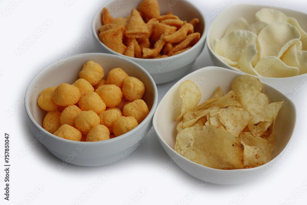 Top view of white ceramic bowls with different kind of chips isolated on white background Top view of white ceramic bowls with different kind of chips isolated on white background