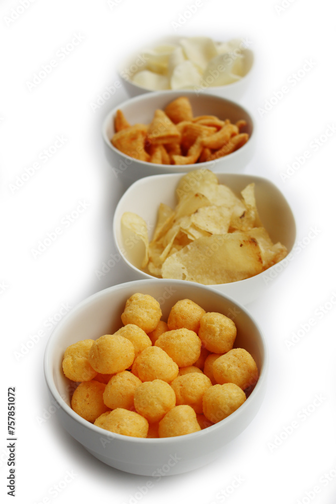 Top view of white ceramic bowls with different kind of chips in a row isolated on white background Top view of white ceramic bowls with different kind of chips in a row isolated on white background