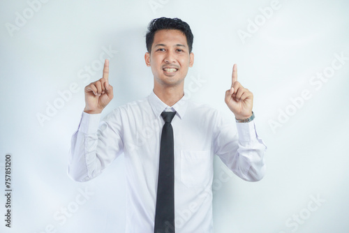 Adult Asian man smiling happy with both hands pointing up photo