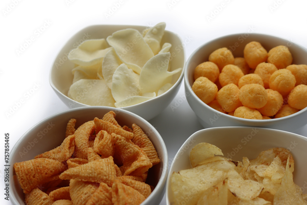 Top view of white ceramic bowls with different kind of chips isolated on white background Top view of white ceramic bowls with different kind of chips isolated on white background