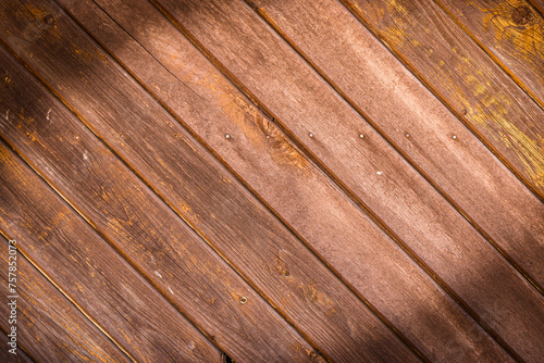 Wooden wall made of diagonal boards with light brown stripes. Background.1