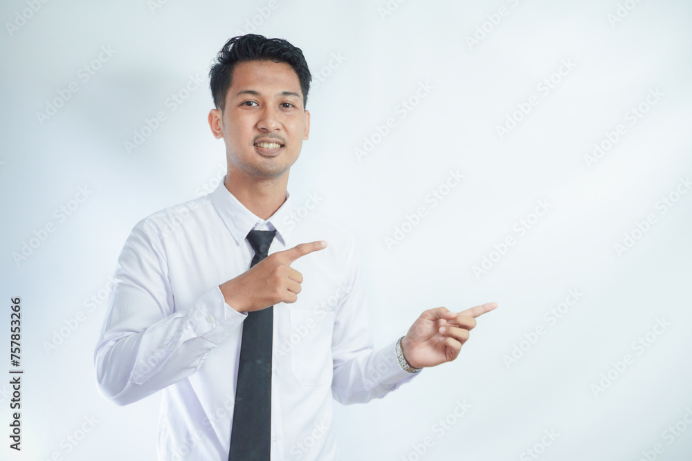 Adult Asian man pointing finger to the left with smiling face Adult Asian man pointing finger to the left with smiling face