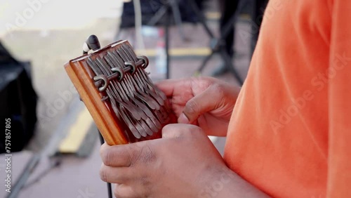 African man playing traditional instrument in a music band