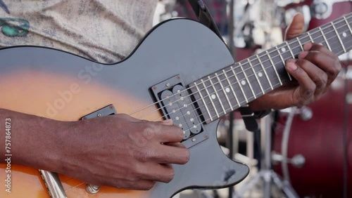 African man playing guitar in a band