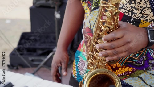 African man playing saxofone in a band