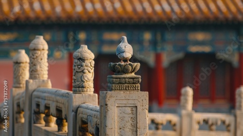 a statue standing on the top of some stone columns, in the style of avian-themed, cloisonnism,  photo