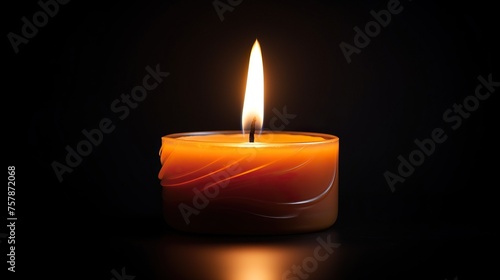 Burning candle with light rays againsts a black background.