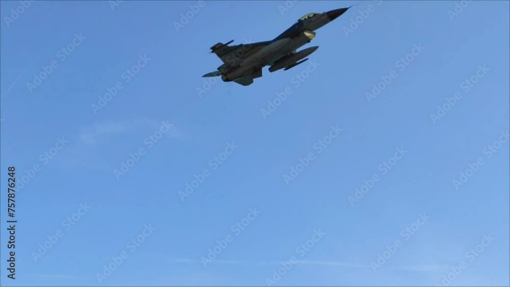A military fighter aircraft flies in the blue sky A military fighter aircraft flies in the blue sky