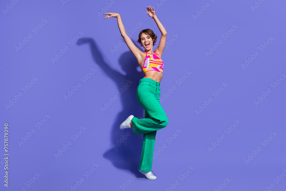 Photo of positive lovely graceful woman wear nice outfit dance with raised hands friday mood isolated on purple color background