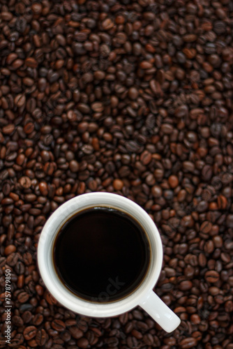 A cup of coffee with coffee beans.